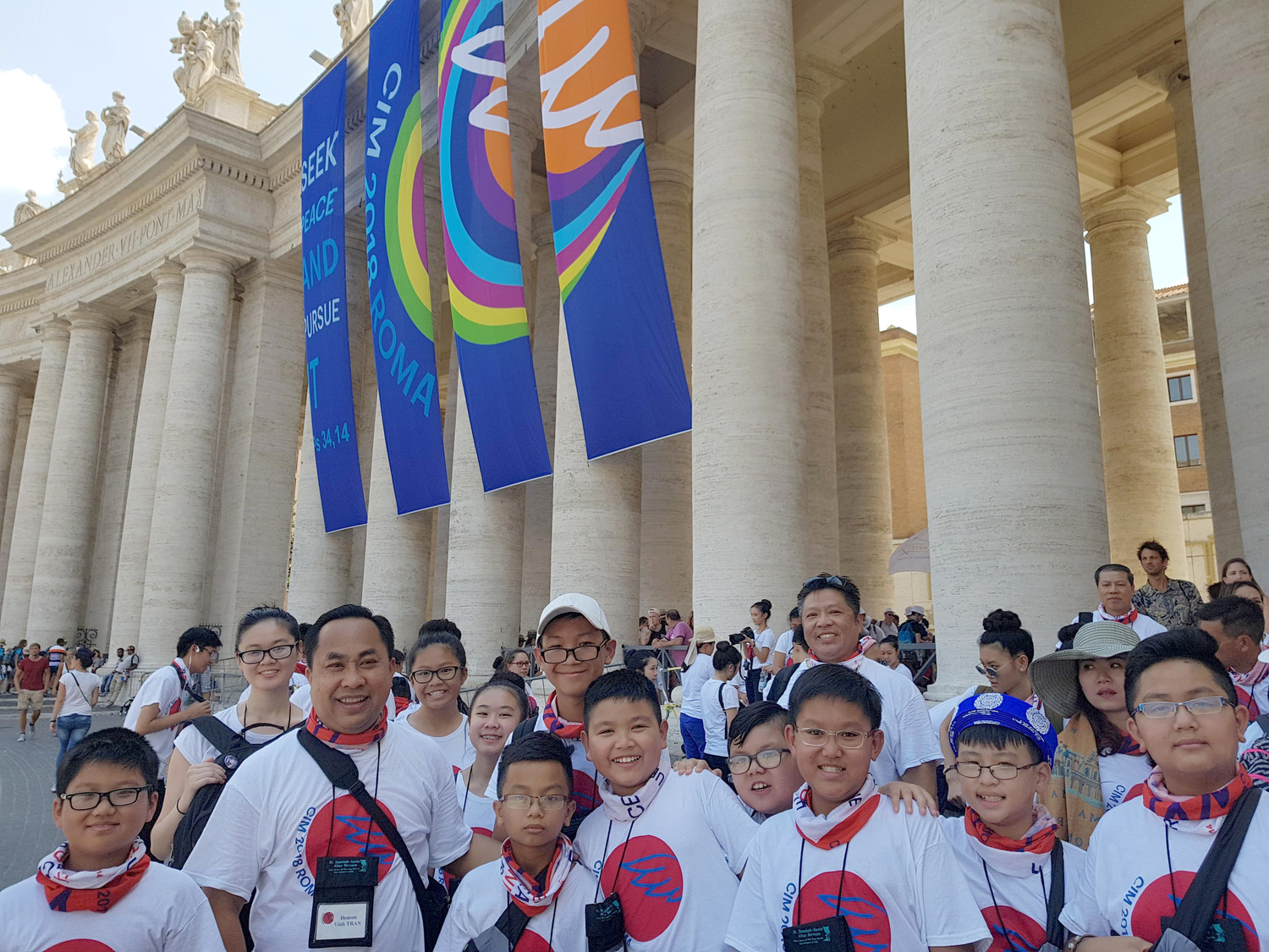 Deacon Vinh Tran, second from left, poses in St. Peter’s Square at the Vatican July 31 with some of the 85 children and parents from the parish of Mary, Queen of Vietnam in New Orleans, Louisiana attending an international pilgrimage of altar servers. The pilgrimage, sponsored by the German bishops’ conference, included tens of thousands of Germans ages 13 to 23 and altar servers from 18 countries.